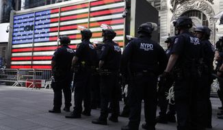 Police officers in riot gear stand by in Times Square during a protest in Manhattan in New York, Monday, June 1, 2020. New York City imposed an 11 p.m. curfew Monday as the nation&#39;s biggest city tried to head off another night of destruction erupting amid protests over George Floyd&#39;s death. (AP Photo/Seth Wenig)