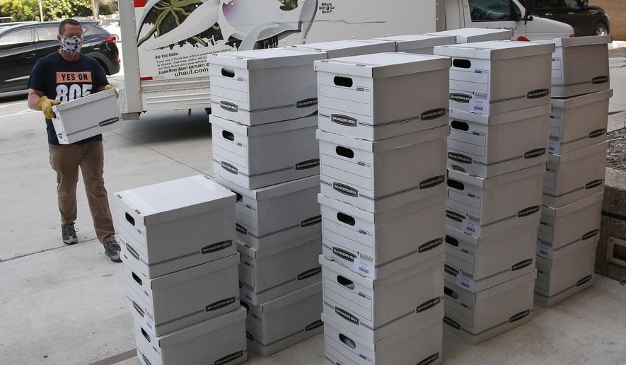 Kris Steele, Executive Director of OCJR and TEEM, carries a box of petitions as Yes on 805 delivers 260,000 gathered signatures to the Secretary of State's office Monday, June 1, 2020, in Oklahoma City, to put sentencing reform on a 2020 ballot. (AP Photo/Sue Ogrocki, Pool)