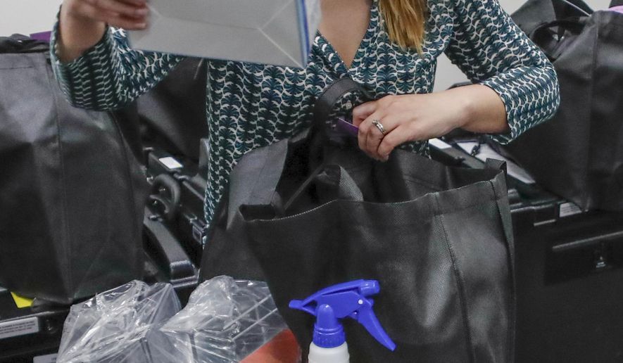 Butler County Bureau of Elections Registrar, Chantell McCurdy packs one of the COVID-19 cleaning and preparedness precinct kits with equipment as protective masks, gloves, hand sanitizers, wipes and sprays for sanitizing, for poll workers for Pennsylvania's June 2nd Primary election before they are sent out from the offices Thursday, May 28, 2020, in Butler, Pa. (AP Photo/Keith Srakocic)