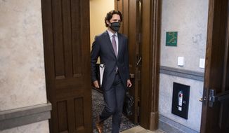 Canada&#39;s Prime Minister Justin Trudeau arrives in the foyer of the House of Commons on Parliament Hill for a meeting of the Special Committee on the COVID-19 Pandemic in Ottawa, Ontario on Wednesday, May 27, 2020. (Justin Tang/The Canadian Press via AP)