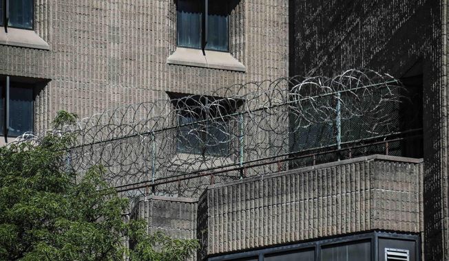 This Aug. 10, 2019, shows razor wire fencing at the Metropolitan Correctional Center in New York. (AP Photo/Bebeto Matthews, File)