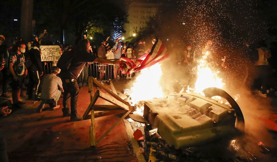 Demonstrators start a fire as they protest the death of George Floyd, Sunday, May 31, 2020, near the White House in Washington. Floyd died after being restrained by Minneapolis police officers (AP Photo/Alex Brandon)