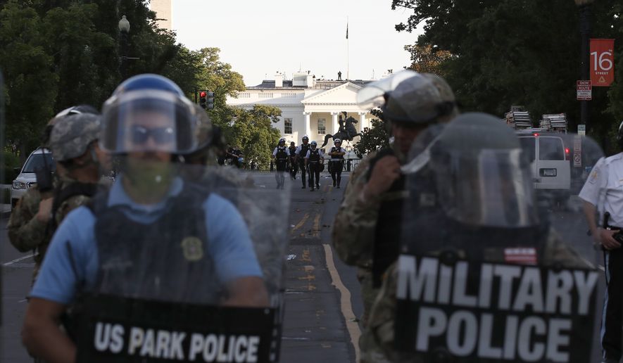 Police clear the area around Lafayette Park and the White House as demonstrators gather to protest the death of George Floyd, Monday, June 1, 2020, in Washington. Floyd died after being restrained by Minneapolis police officers. (AP Photo/Alex Brandon)