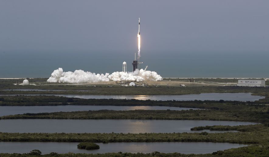 The SpaceX Falcon 9 and the Crew Dragon capsule, with NASA astronauts Bob Behnken and Doug Hurley onboard, lifts off Saturday, May 30, 2020, at the Kennedy Space Center in Cape Canaveral, Fla. (AP Photo/Chris O&#39;Meara)