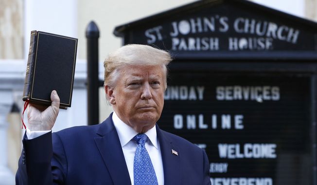 President Donald Trump holds a Bible as he visits outside St. John&#x27;s Church across Lafayette Park from the White House Monday, June 1, 2020, in Washington. Part of the church was set on fire during protests on Sunday night. (AP Photo/Patrick Semansky)