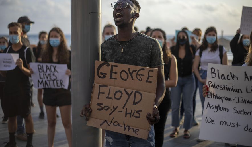 Protesters shout slogans during a protest to decry the killing of George Floyd in front of the American embassy in Tel Aviv, Israel, Tuesday, June 2, 2020. (AP Photo/Ariel Schalit)