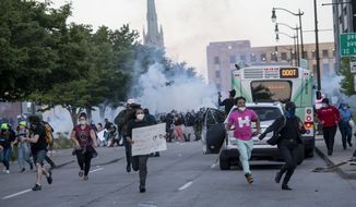 Detroit police fire tear gas at protesters during the third day of protesting police brutality and justice for George Floyd Sunday May 31, 2020 in Detroit. (Nicole Hester/Ann Arbor News via AP)