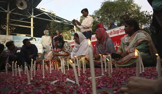 People attend candlelight vigil for victims of the crash of a state-run Pakistan International Airlines plane, in Karachi, Pakistan, Thursday , May 28, 2020. (AP Photo/Fareed Khan)