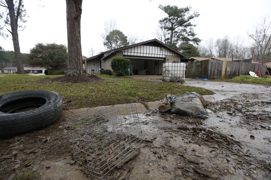 A variety of debris deposited by the floodwaters of the Pearl River, litter the streets in the northeast Jackson, Miss., neighborhoods affected by the flooding, Wednesday, Feb. 19, 2020. Hundreds of homes and businesses remain without power as floodwaters recede around Jackson, Mississippi, and it's unclear when the lights will come back on. (AP Photo/Rogelio V. Solis)