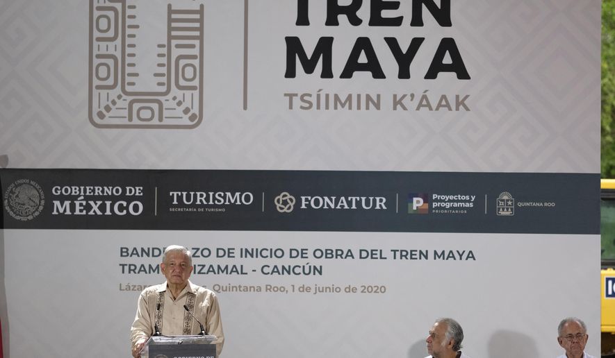 Mexican President Andres Manuel Lopez Obrador, left, speak during a ceremony in Lazaro Cardenas, Quintana Roo state, Mexico, Monday, June 1, 2020. Amid a pandemic and the remnants of a tropical storm, President Lopez Obrador kicked off Mexico's return to a "new normal" Monday with his first road trip in two months as the nation began to gradually ease some virus-inspired restrictions. (AP Photo/Victor Ruiz)