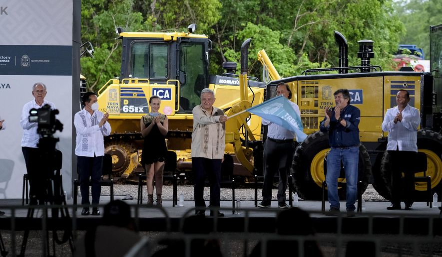 Mexican President Andres Manuel Lopez Obrador waves a starting flag during a ceremony in Lazaro Cardenas, Quintana Roo state, Mexico, Monday, June 1, 2020. Amid a pandemic and the remnants of a tropical storm, President Lopez Obrador kicked off Mexico&#x27;s return to a &amp;quot;new normal&amp;quot; Monday with his first road trip in two months as the nation began to gradually ease some virus-inspired restrictions. (AP Photo/Victor Ruiz)