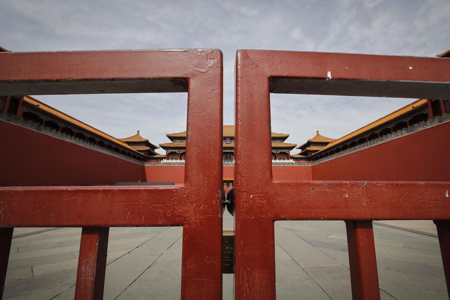 In this Thursday, March 12, 2020, file photo, an entrance gate is closed at the usually crowded Forbidden City in Beijing, due to the COVID-19 coronavirus outbreak. (AP Photo/Andy Wong)