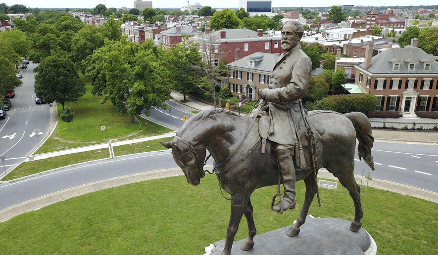 This Tuesday, June 27, 2017, file photo shows the statue of Confederate General Robert E. Lee that stands in the middle of a traffic circle on Monument Avenue in Richmond, Va. Virginia Gov. Ralph Northam is expected to announce plans Thursday for the removal of an iconic statue of Confederate Gen. Robert E. Lee from Richmond&#x27;s prominent Monument Avenue. (AP Photo/Steve Helber, File)