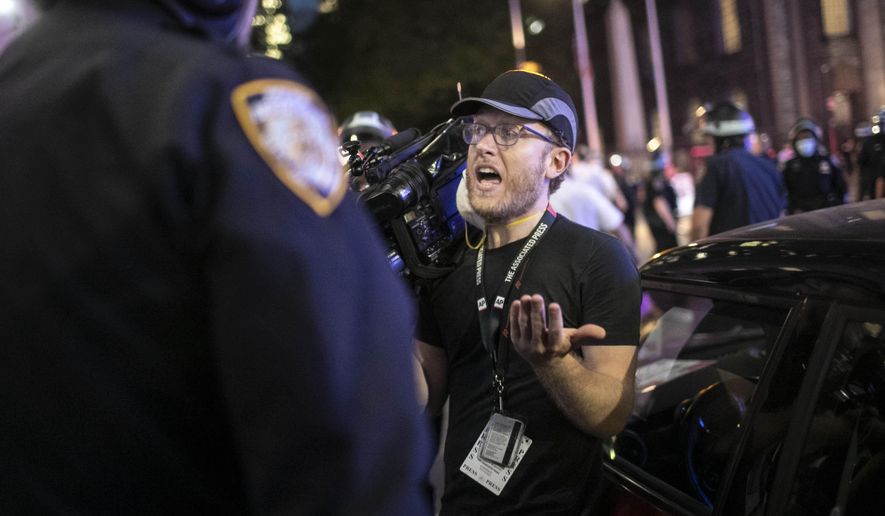 Associated Press videojournalist Robert Bumsted reminds a police officer that the press are considered “essential workers&amp;quot; and are allowed to be on the streets despite a curfew, Tuesday, June 2, 2020, in New York. New York City police officers surrounded, shoved and yelled expletives at two Associated Press journalists covering protests in the latest aggression against members of the media during a week of unrest around the country. Portions of the incident were captured on video by Bumsted, who was working with photographer Wong Maye-E to document the protests in lower Manhattan over the killing of George Floyd in Minneapolis.(AP Photo/Wong Maye-E)