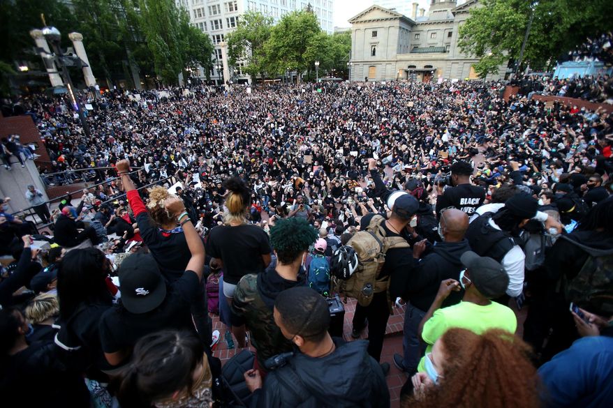 A crowd gather in Pioneer Square in downtown Portland by dusk on Tuesday, June 2, 2020 as protests continued for a sixth night in Portland, demonstrating against the death of George Floyd. Floyd died after being restrained by Minneapolis police officers on May 25.(Sean Meagher/The Oregonian via AP)