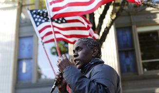 A protester demonstrates in and around Pioneer Square in Portland, Tuesday evening, June 2, 2020, following the death of George Floyd, a black man who died in police custody on Memorial Day in Minneapolis. (Sean Meagher/The Oregonian via AP)