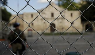 A member of the National Guard and the Alamo are seen behind a newly erected protective fence in San Antonio, Wednesday, June 3, 2020. The grounds are being protected with the fence and a curfew as a precautionary measure to minimize the possibility of civil disturbance and damage to sensitive structures as protests have broken out over the death of George Floyd.  Demonstrators took to the streets across the United States again Wednesday to protest the death of Floyd, a black man who was killed in police custody in Minneapolis on May 25. (AP Photo/Eric Gay)