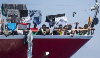 Migrants dry their clothes aboard a tourist boats some 20 kilometers from Malta, Tuesday, June 2, 2020. More than 400 migrants are living aboard pleasure cruise vessels, bobbing in the sea off Malta, many of them for weeks now. Rescued from human traffickers’ unseaworthy boats in several operations in the central Mediterranean since late April, the migrants, along with the Maltese government, are waiting for European Union countries to offer to take them. (AP Photo/Rene&#39; Rossignaud)