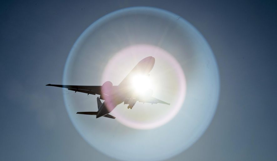 In this March 18, 2020 file photo, a Southern China Airlines flight from Guangzhou, China, passes in front of the sun as it arrives at Vancouver International Airport in Richmond, British Columbia, Canada. On Wednesday, June 3, 2020, the Trump administration moved to block Chinese airlines from flying to the U.S. in an escalation of trade and travel tensions between the two countries. (Jonathan Hayward/The Canadian Press via AP)