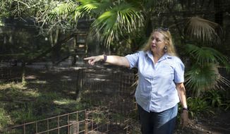 FILE - In this July 20, 2017, file photo, Carole Baskin, founder of Big Cat Rescue, walks the property near Tampa, Fla. A federal judge in Oklahoma has awarded ownership of the zoo made famous in Netflix&#39;s “Tiger King” docuseries to Joe Exotic&#39;s rival, Carole Baskin. In a ruling Monday, June 1, 2020, U.S. District Judge Scott Palk granted control of the Oklahoma zoo that was previously run by Joseph Maldonado-Passage — also known as Joe Exotic — to Big Cat Rescue Corp.  (Loren Elliott/Tampa Bay Times via AP, File)