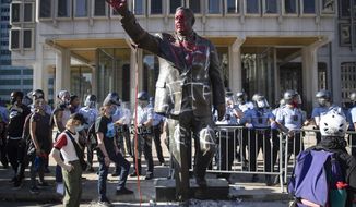 In this Saturday, May 30, 2020, photo police stand near a vandalized statue of controversial former Philadelphia Mayor Frank Rizzo in Philadelphia, during protests over the death of George Floyd, who died May 25 after he was restrained by Minneapolis police. Workers early Wednesday, June 3 removed the statue which was recently defaced during the weekend protest. (AP Photo/Matt Rourke)