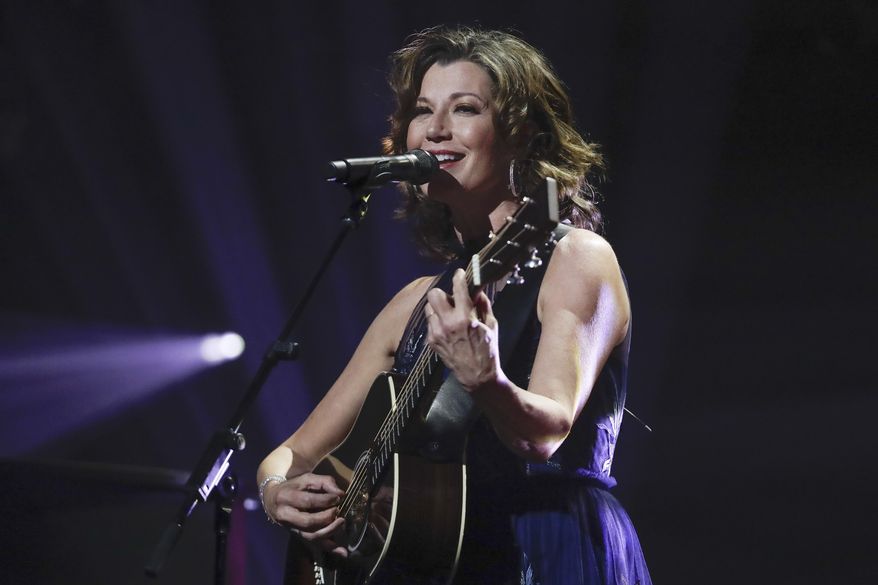FILE - In this Oct. 15, 2019 file photo, singer Amy Grant performs during the Dove Awards in Nashville, Tenn. Grant has had open heart surgery to fix a heart condition she has had since birth. A publicist for the singer said doctors discovered the condition during a routine checkup. Grant is married to country singer Vince Gill and is a six-time Grammy winner with hits like “Baby, Baby,” and “That's What Love is For." (AP Photo/Mark Humphrey, File)