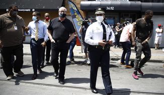 Philadelphia Police Commissioner Danielle Outlaw, center, and Mayor Jim Kenney, 4th left, meet with people, Thursday, June 4, 2020, in Philadelphia after days of protest over the May 25 death of George Floyd, who died after being restrained by police in Minneapolis. (AP Photo/Matt Rourke)