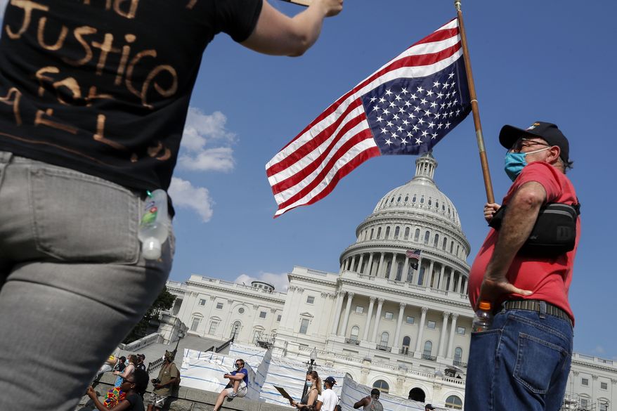 Demonstrators protest Thursday, June 4, 2020, on the West Front of the U.S. Capitol in Washington, over the death of George Floyd, a black man who was in police custody in Minneapolis. Floyd died after being restrained by Minneapolis police officers. (AP Photo/Alex Brandon)