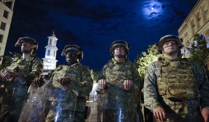 Utah National Guard soldiers stand on a police line as demonstrators gather to protest the death of George Floyd, Thursday, June 4, 2020, near the White House in Washington. Floyd died after being restrained by Minneapolis police officers. (AP Photo/Alex Brandon)