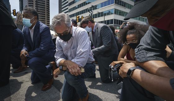Philadelphia District Attorney Larry Krasner takes a knee in honor of the memory of George Floyd on Thursday, June 4, 2020, in Philadelphia. (Jessica Griffin/The Philadelphia Inquirer via AP) ** FILE **