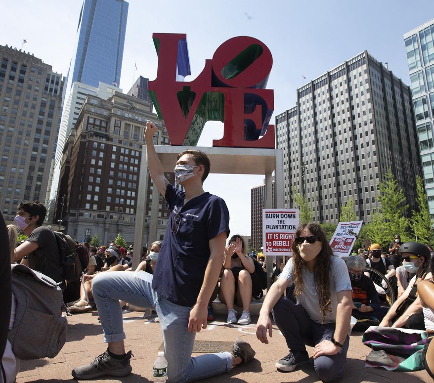 Protesters rally at LOVE Park on Thursday, June 4, 2020, in Philadelphia during a demonstration over the death of George Floyd, who died May 25 after being restrained by police in Minneapolis. (Charles Fox/The Philadelphia Inquirer via AP)