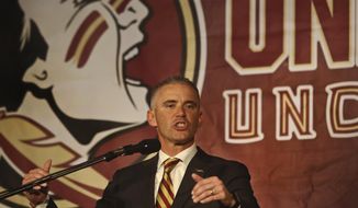 FILE - In this Dec. 8, 2019, file photo, Florida State head football coach Mike Norvell speaks at a press conference in Tallahassee, Fla. Florida State athletic director David Coburn says the football team met Thursday, June 4, 2020, after a star player accused coach Mike Norvell of lying about connecting personally last weekend with every player to discuss the killing of George Floyd and protests against racial injustice. (AP Photo/Phil Sears, File)