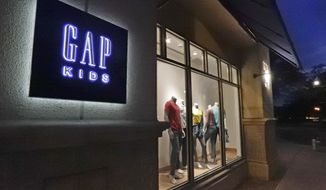 FILE - This Aug. 23, 2018, file photo shows a window display at a Gap Kids clothing store in Winter Park, Fla. Gap is being sued for refusing to pay rent for stores temporarily closed during the coronavirus pandemic. Mall owner Simon Property Group says in a lawsuit filed this week of June 4, 2020, that the clothing retailer owes three months of rent, totaling $65.9 million AP Photo/John Raoux, File)