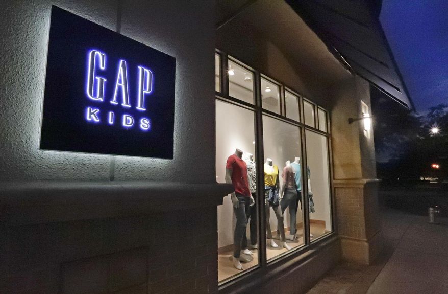 FILE - This Aug. 23, 2018, file photo shows a window display at a Gap Kids clothing store in Winter Park, Fla. Gap is being sued for refusing to pay rent for stores temporarily closed during the coronavirus pandemic. Mall owner Simon Property Group says in a lawsuit filed this week of June 4, 2020, that the clothing retailer owes three months of rent, totaling $65.9 million AP Photo/John Raoux, File)