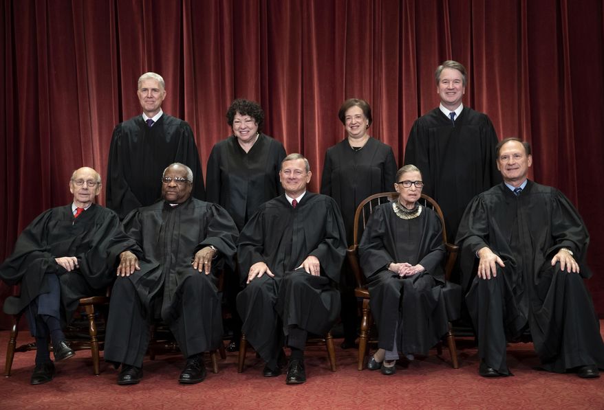 In this Nov. 30, 2018, file photo, the justices of the U.S. Supreme Court gather for a formal group portrait to include the new Associate Justice, top row, far right, at the Supreme Court building in Washington.  (AP Photo/J. Scott Applewhite, File)  **FILE**