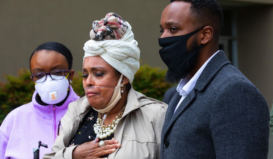 Marcia Carter-Patterson, center, mother of Manny Ellis, speaks at a press conference in front of the Pierce County Superior Court in Tacoma Thursday, June 4, 2020 regarding the killing of her son by Tacoma police. At left is Manny's sister Monet Carter-Mixon and at right is his brother Matthew Ellis. Tacoma police's restraint of Manuel Ellis caused his death the medical examiner has reported. The community has been protesting the death that happened March 3, 2020, for the past week. (Ellen M. Banner./The Seattle Times via AP)