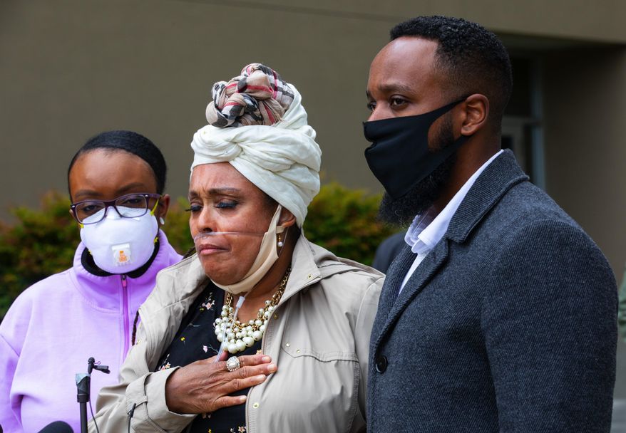 Marcia Carter-Patterson, center, mother of Manny Ellis, speaks at a press conference in front of the Pierce County Superior Court in Tacoma Thursday, June 4, 2020 regarding the killing of her son by Tacoma police. At left is Manny's sister Monet Carter-Mixon and at right is his brother Matthew Ellis. Tacoma police's restraint of Manuel Ellis caused his death the medical examiner has reported. The community has been protesting the death that happened March 3, 2020, for the past week. (Ellen M. Banner./The Seattle Times via AP)