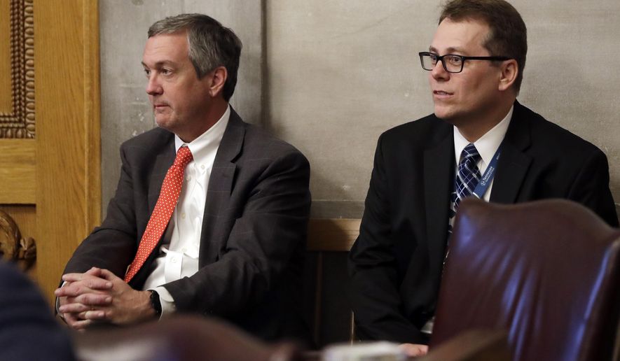 FILE - In this April 15, 2019, file photo, Tennessee Secretary of State Tre Hargett, left, attends a House session, in Nashville, Tenn. Hargett, who had previously argued the original 2019 voter registration law would bolster election security, is submitting a separate bill in 2020 that will criminalize “intentional dissemination of misinformation” surrounding the qualifications to vote, voter registration requirements, voter eligibility and polling dates, times and locations. (AP Photo/Mark Humphrey, File)