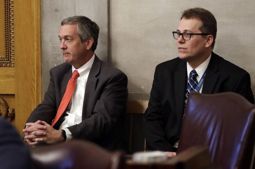 FILE - In this April 15, 2019, file photo, Tennessee Secretary of State Tre Hargett, left, attends a House session, in Nashville, Tenn. Hargett, who had previously argued the original 2019 voter registration law would bolster election security, is submitting a separate bill in 2020 that will criminalize “intentional dissemination of misinformation” surrounding the qualifications to vote, voter registration requirements, voter eligibility and polling dates, times and locations. (AP Photo/Mark Humphrey, File)