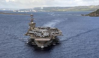 PHILIPPINE SEA (June 4, 2020)In this June 4, 2020, photo provided by the U.S. Navy, the aircraft carrier USS Theodore Roosevelt (CVN 71) departs Apra Harbor in Guam. The carrier has returned to sea and is conducting military operations in the Pacific region, 10 weeks after a massive coronavirus outbreak sidelined Navy warship. (Mass Communication Specialist Seaman Kaylianna Genier/U.S. Navy via AP))