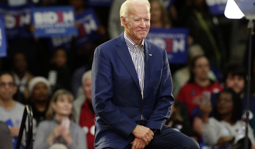 In this Feb. 29, 2020, file photo Democratic presidential candidate former Vice President Joe Biden smiles at supporters during a campaign event at Saint Augustine's University in Raleigh, N.C. Biden has won the last few delegates he needed to clinch the Democratic nomination for president. (AP Photo/Gerry Broome, File)