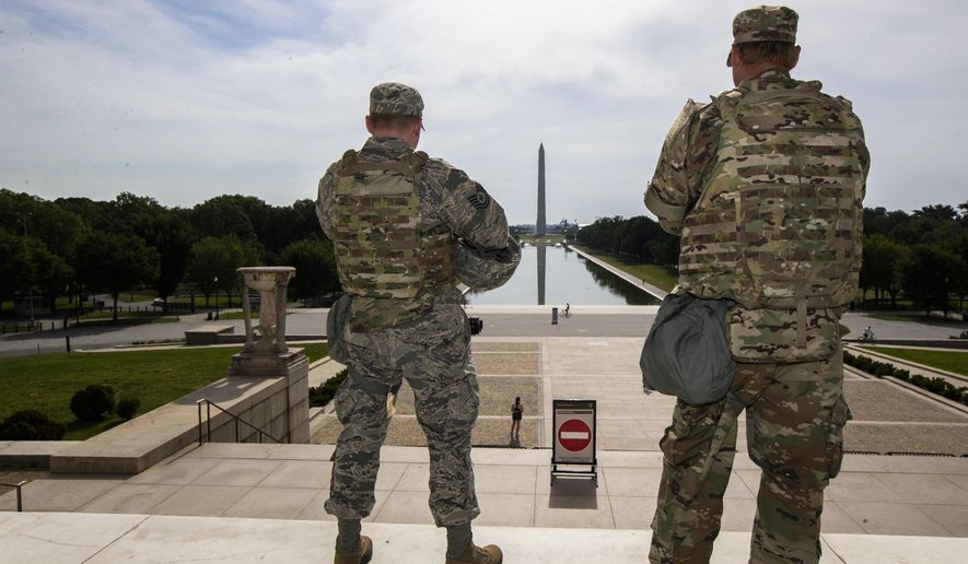 In this June 3, 2020 file photo members of the District of Columbia Army National Guard stand guard at the Lincoln Memorial in Washington securing the area as protests continue following the death of George Floyd, a who died after being restrained by Minneapolis police officers. An Ohio National Guardsman was removed from policing protests in Washington D.C. after the FBI found he expressed white supremacist ideology online, Gov. Mike DeWine announced in a briefing Friday, June 5, 2020. (AP Photo/Manuel Balce Ceneta)