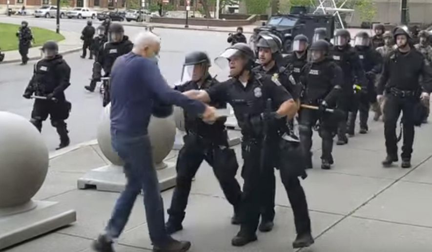In this image from video provided by WBFO, a Buffalo police officer appears to shove a man who walked up to police Thursday, June 4, 2020, in Buffalo, N.Y. Video from WBFO shows the man appearing to hit his head on the pavement, with blood leaking out as officers walk past to clear Niagara Square. Buffalo police initially said in a statement that a person “was injured when he tripped &amp;amp; fell,” WIVB-TV reported, but Capt. Jeff Rinaldo later told the TV station that an internal affairs investigation was opened. Police Commissioner Byron Lockwood suspended two officers late Thursday, the mayor’s statement said. (Mike Desmond/WBFO via AP)