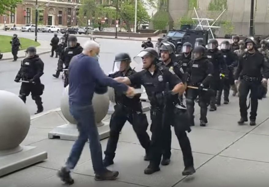 In this image from video provided by WBFO, a Buffalo police officer appears to shove a man who walked up to police Thursday, June 4, 2020, in Buffalo, N.Y. Video from WBFO shows the man appearing to hit his head on the pavement, with blood leaking out as officers walk past to clear Niagara Square. Buffalo police initially said in a statement that a person “was injured when he tripped &amp;amp; fell,” WIVB-TV reported, but Capt. Jeff Rinaldo later told the TV station that an internal affairs investigation was opened. Police Commissioner Byron Lockwood suspended two officers late Thursday, the mayor’s statement said. (Mike Desmond/WBFO via AP)