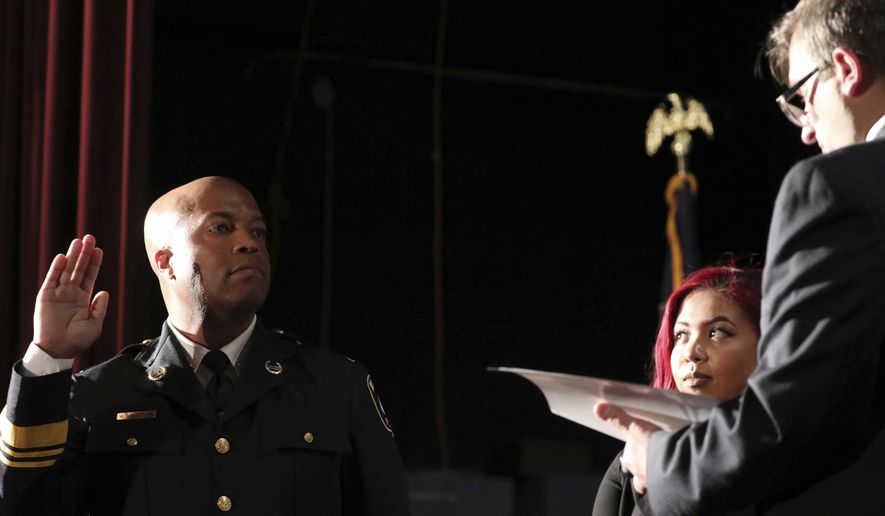 FILE - In this Sept. 8, 2017, file photo, newly appointed Minneapolis Police Chief Medaria Arradondo takes the oath of office as his daughter Nyasia looks on during a public swearing-in ceremony, in Minneapolis. George Floyd’s death and the protests it ignited nationwide over racial injustice and police brutality have raised questions about whether Arradondo — or any chief — can fix a department that's now facing a civil rights investigation. (Anthony Souffle/Star Tribune via AP, File)