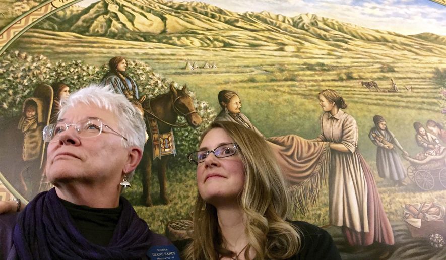 FILE - In this Jan. 7, 2015, file photo, State Sen. Diane Sands, left, and artist Hadley Ferguson of Missoula stand in front of a mural honoring Montana women as community builders at its unveiling at the state Capitol in Helena, Mont. Members of the Montana Democratic Party met remotely on Friday, June 5, 2020, to vote on the party's platform, including the addition of a statement in reaction by the death of George Floyd opposing the use of force by law enforcement during arrests. Sen. Diane Sands, D-Missoula, who led a Zoom meeting on the party's crime and justice platform, voiced support for the amendment. "I think it is important that we address the current national situation," Sands said. "It's good to talk about it in here, and make sure that people know that's what we stand for. (AP Photo/Lisa Baumann, File)