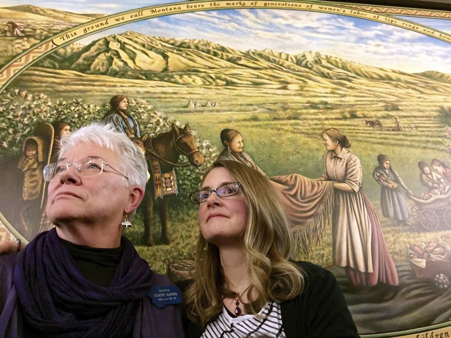 FILE - In this Jan. 7, 2015, file photo, State Sen. Diane Sands, left, and artist Hadley Ferguson of Missoula stand in front of a mural honoring Montana women as community builders at its unveiling at the state Capitol in Helena, Mont. Members of the Montana Democratic Party met remotely on Friday, June 5, 2020, to vote on the party's platform, including the addition of a statement in reaction by the death of George Floyd opposing the use of force by law enforcement during arrests. Sen. Diane Sands, D-Missoula, who led a Zoom meeting on the party's crime and justice platform, voiced support for the amendment. "I think it is important that we address the current national situation," Sands said. "It's good to talk about it in here, and make sure that people know that's what we stand for. (AP Photo/Lisa Baumann, File)