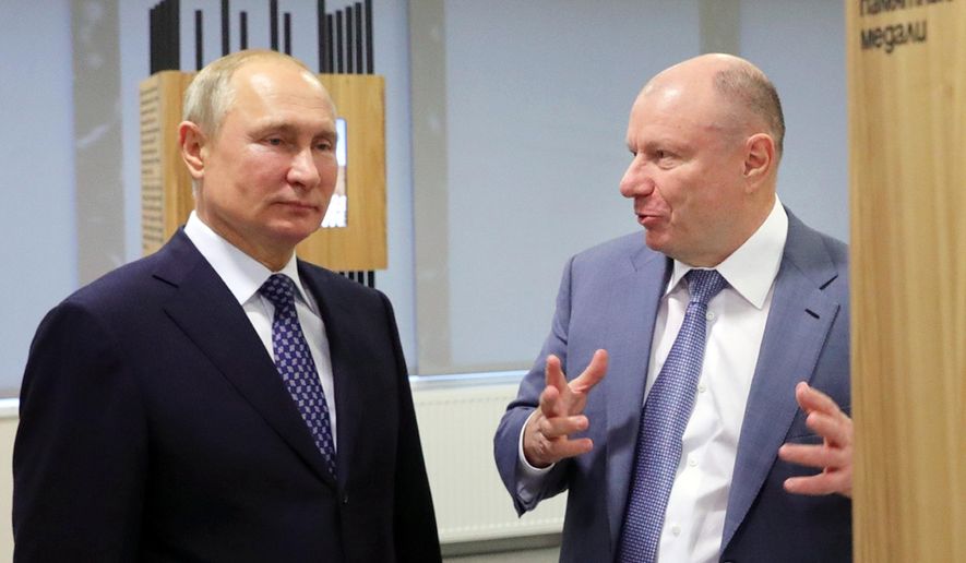 In this file pool photo taken on Tuesday, Dec. 3, 2019, Vladimir Potanin, the billionaire owner of a nickel giant, right, gestures while speaking to Russian President Vladimir Putin in Sochi, Russia. Mr. Potanin is one of the targets of a new Twitter account, @RUOligarchJets, that tracks the whereabouts of aircraft owned by Russian oligarchs. (Mikhail Klimentyev, Sputnik, Kremlin Pool Photo via AP, File) **FILE**