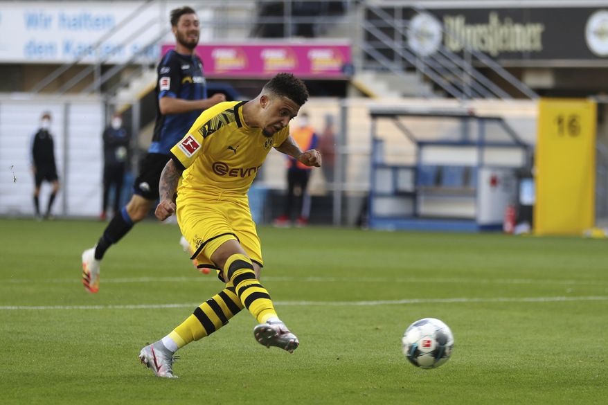 Jadon Sancho of Borussia Dortmund scores his teams sixth goal during the German Bundesliga soccer match between SC Paderborn 07 and Borussia Dortmund at Benteler Arena in Paderborn, Germany, Sunday, May 31, 2020. Because of the coronavirus outbreak all soccer matches of the German Bundesliga take place without spectators. (Lars Baron/Pool via AP)