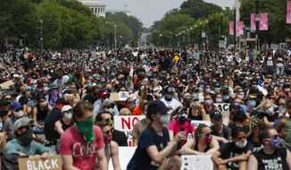 Demonstrators protest Saturday, June 6, 2020, in Washington, over the death of George Floyd, a black man who was in police custody in Minneapolis. Floyd died after being restrained by Minneapolis police officers. (AP Photo/Alex Brandon)